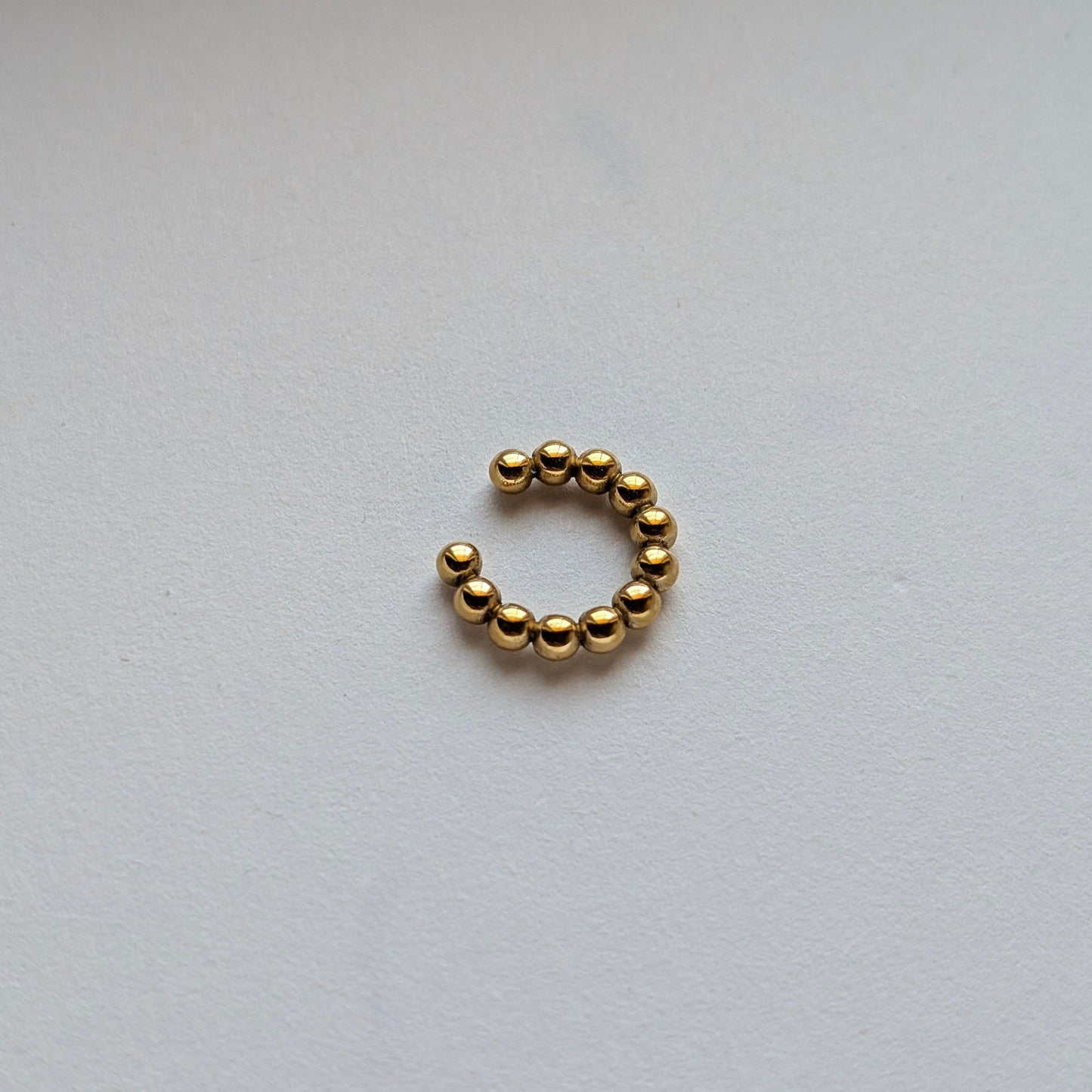 Macro shot of gold bead texture and high‑quality PVD coating for tarnish resistance.