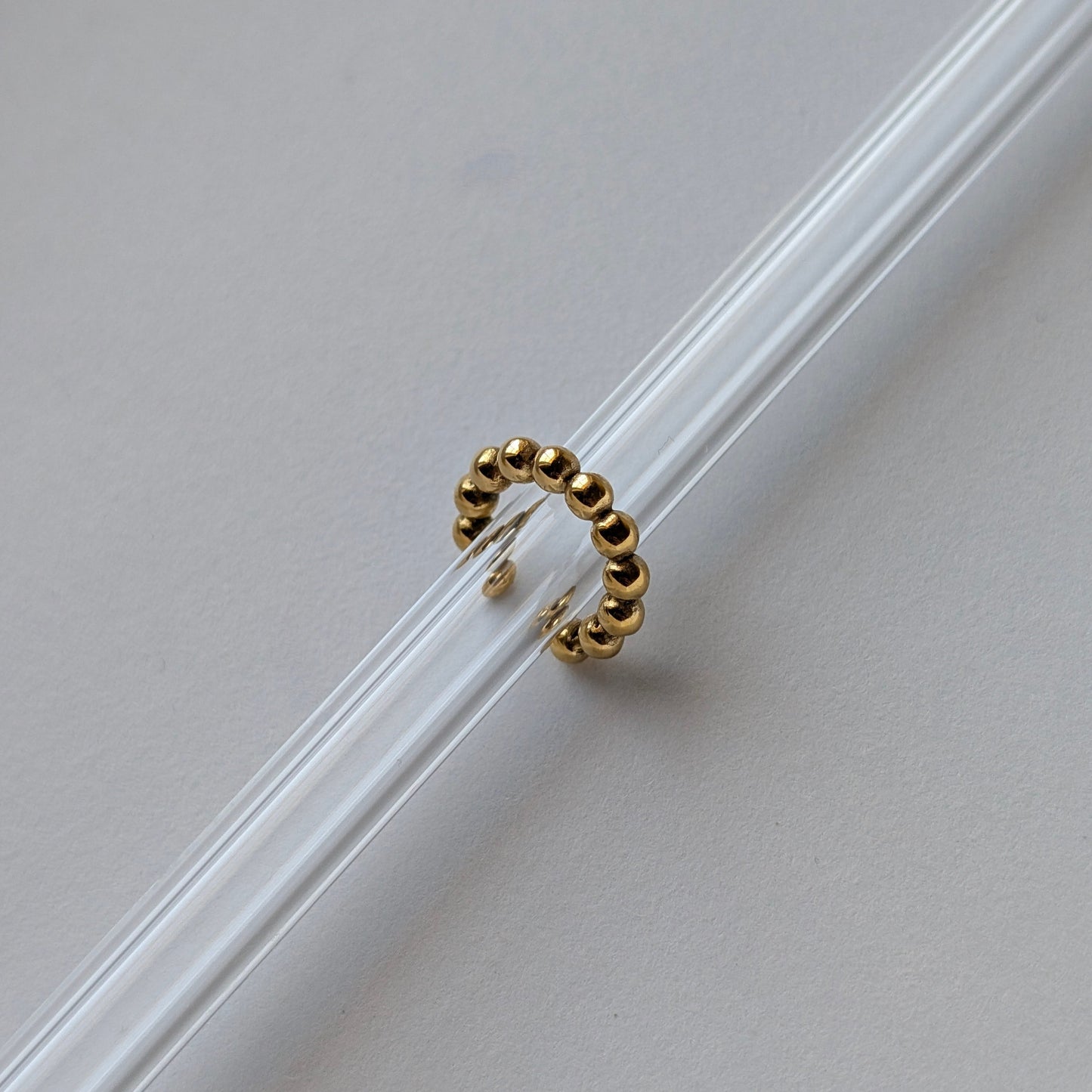 Gold beaded ear cuff beside ruler showing 1.54 cm diameter mini size reference.