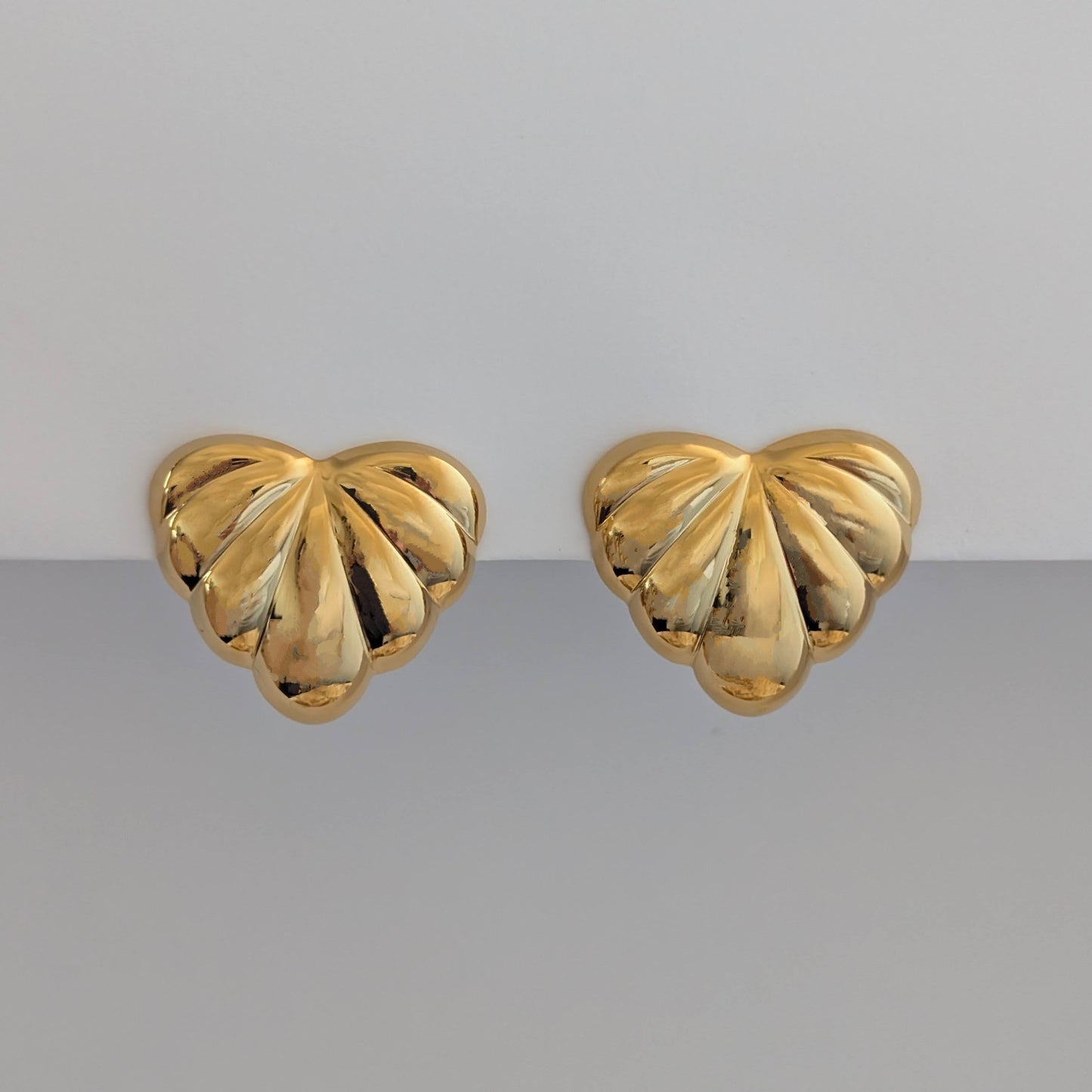 Front view of gold palm leaf statement earrings – 18k plated, high‑shine finish.