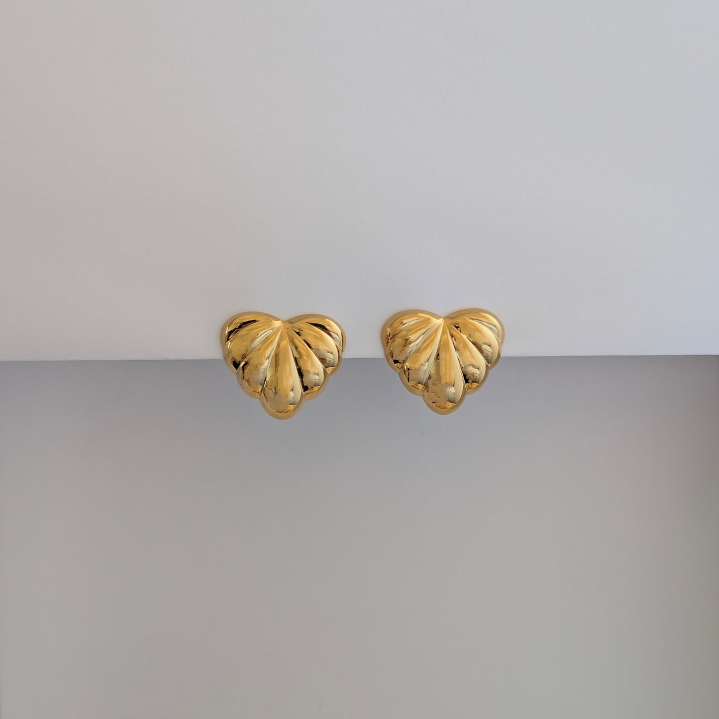 Front view of gold palm leaf statement earrings – 18k plated, high‑shine finish.