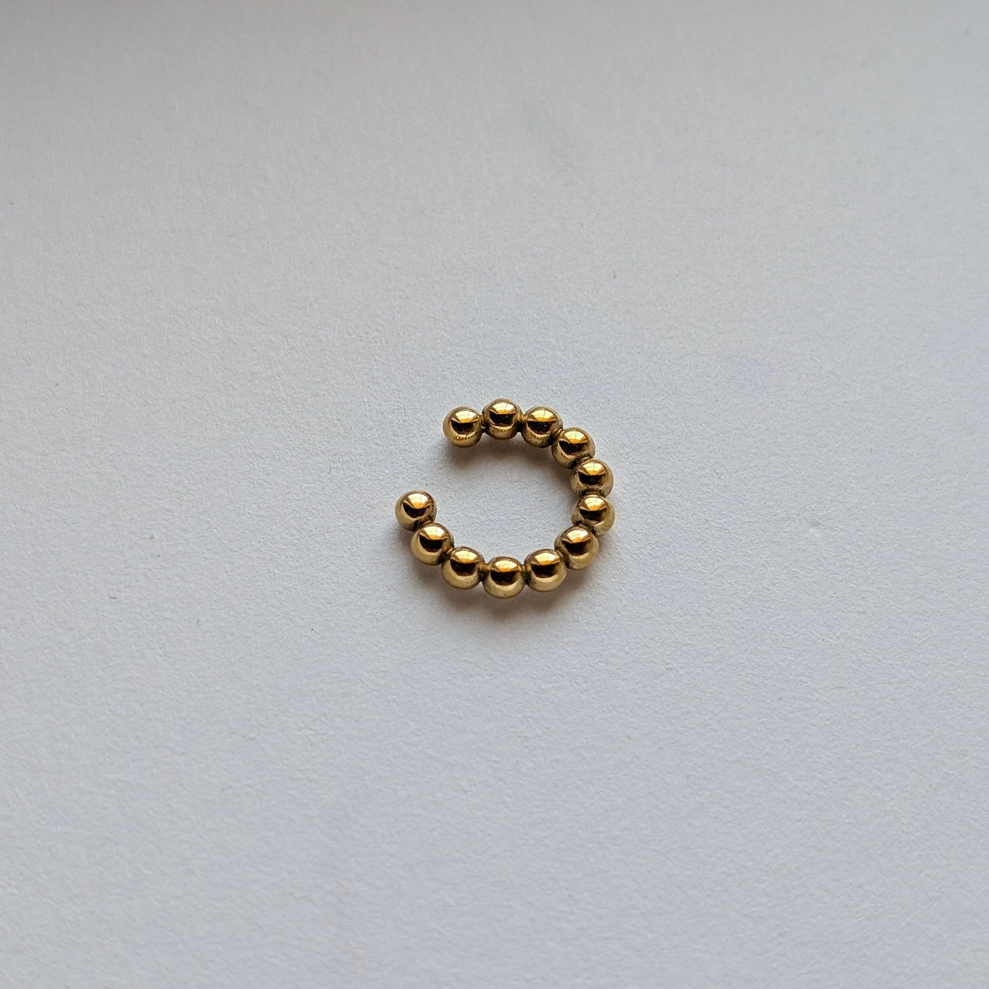 Macro shot of gold bead texture and high‑quality PVD coating for tarnish resistance.