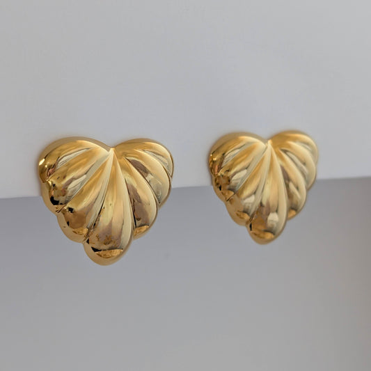 Side angle showing sculpted palm leaves and 2.6 × 3 cm size on gold statement earrings.